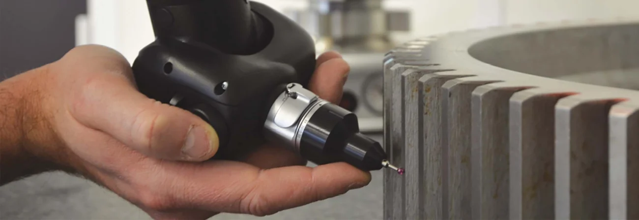 Portable measuring arm probe inspecting a metal gear