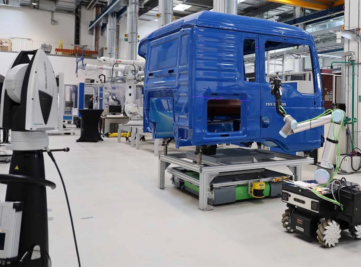 Hexagon AS1‑XL Automated Large-Surface Inspection Hexagon Absolute Scanner AS1‑XL in a robotic inspection setup measuring a vehicle cab with a Leica Absolute Tracker AT960
