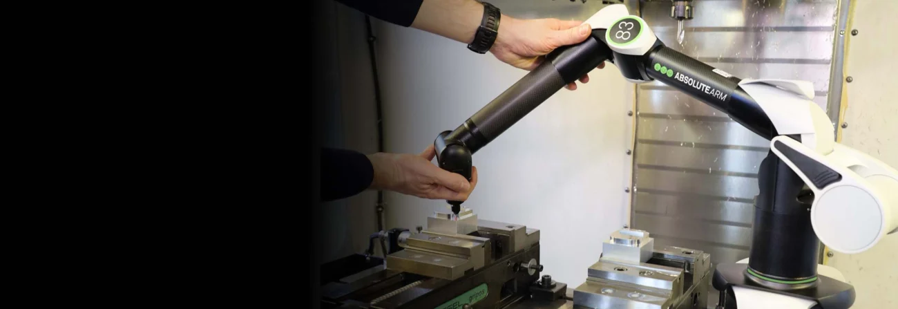 Hexagon Absolute Arm Compact performing touch-probe measurement inside a CNC machine