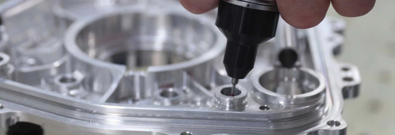 Touch probe measuring a precision-machined metal component