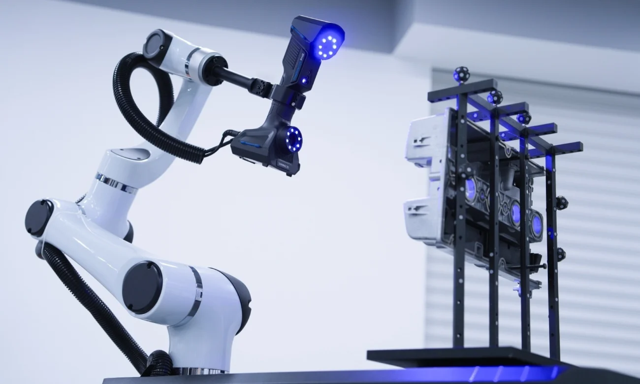 SHINING 3D RobotScan UE Pro2 Automated Laser 3D Scanning RobotScan UE Pro2 with blue laser 3D scanner mounted on a robotic arm for automated inspection of an industrial metal component.